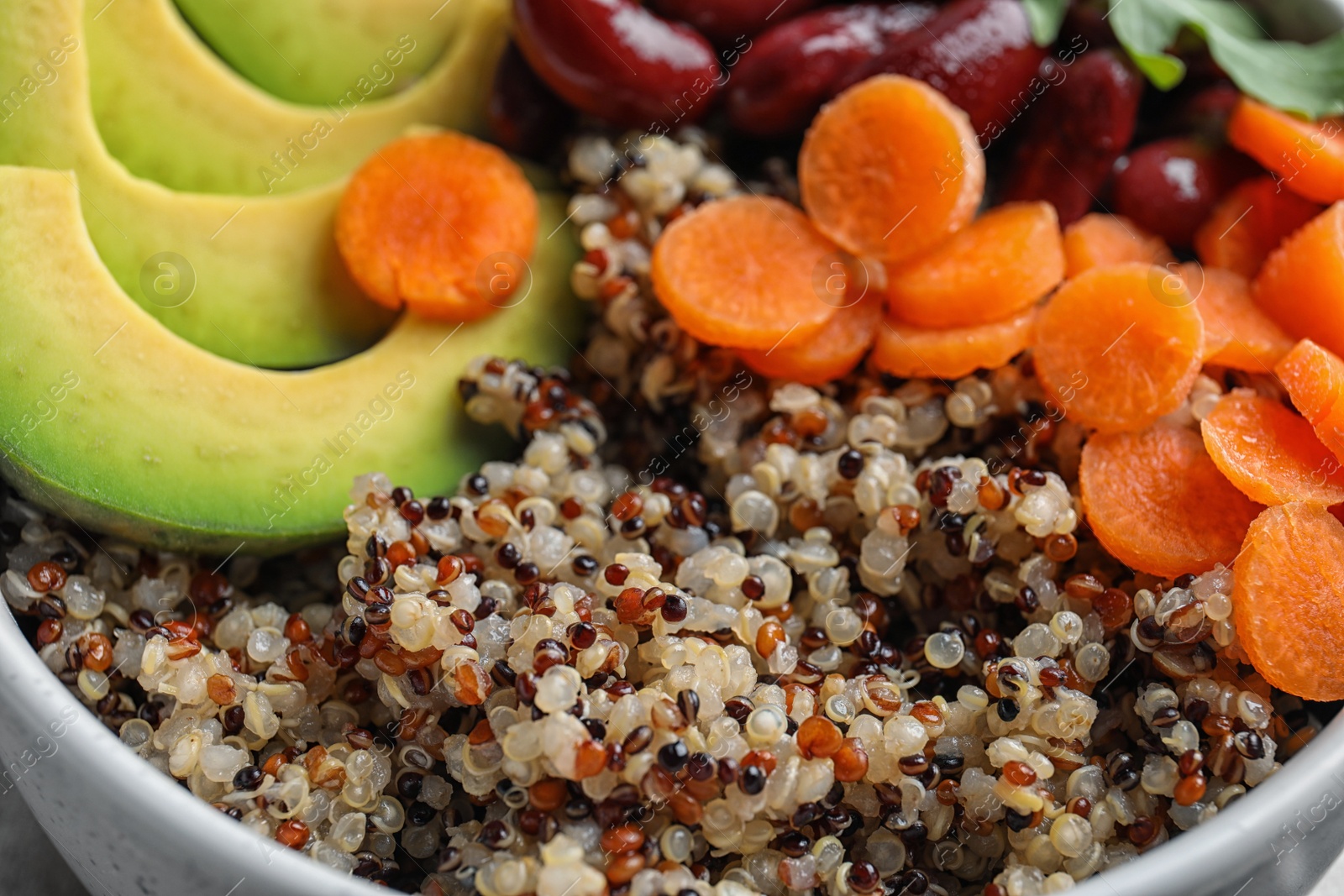 Photo of Healthy quinoa salad with vegetables in bowl, closeup