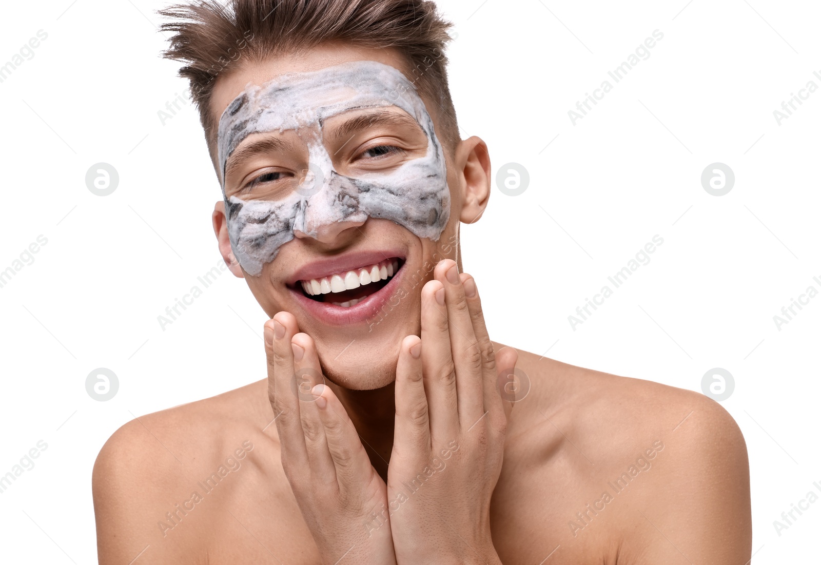 Photo of Handsome man with clay mask on his face against white background