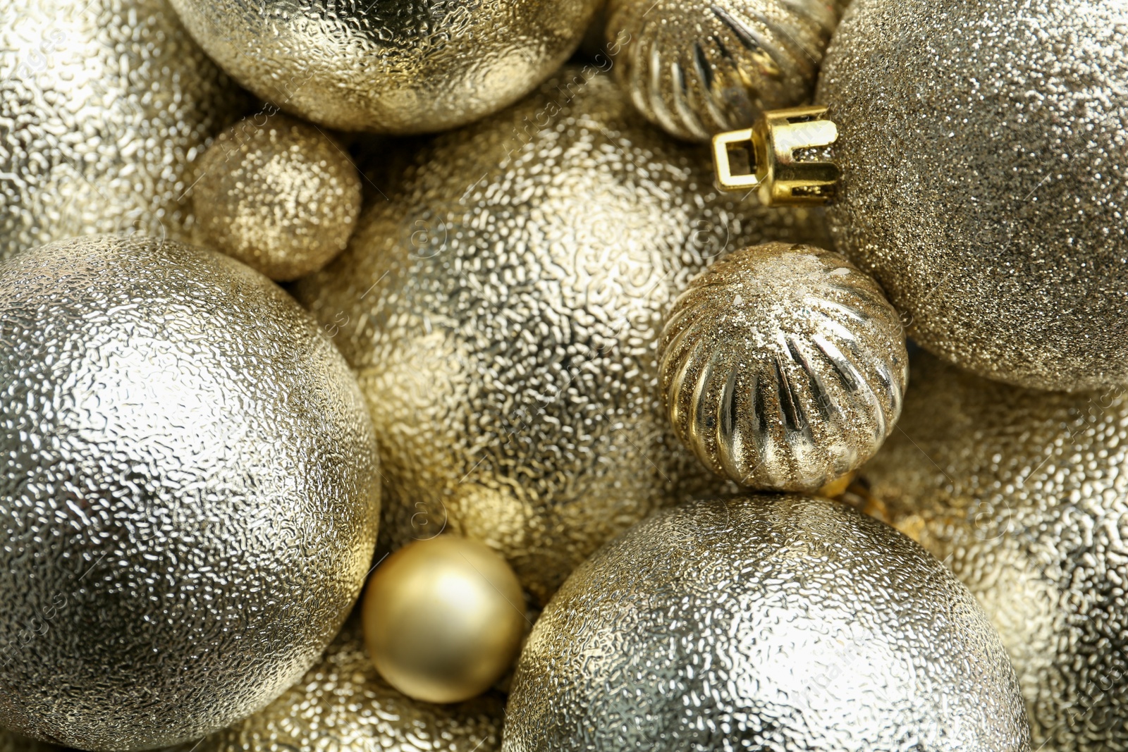 Photo of Beautiful shiny golden Christmas balls as background, top view