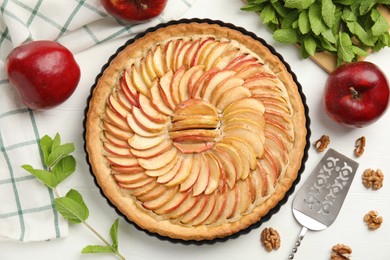 Flat lay composition with delicious homemade apple tart on white wooden table