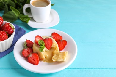 Tasty vanilla fondant with white chocolate and strawberries on light blue wooden table, space for text