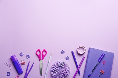 Photo of Bright school stationery on lilac background, flat lay. Space for text