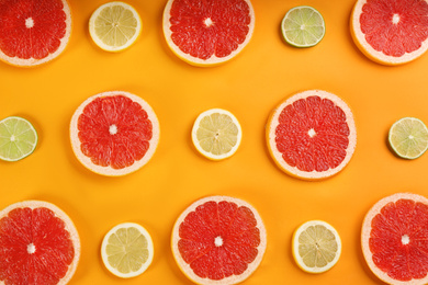 Photo of Flat lay composition with tasty ripe grapefruit slices on orange background