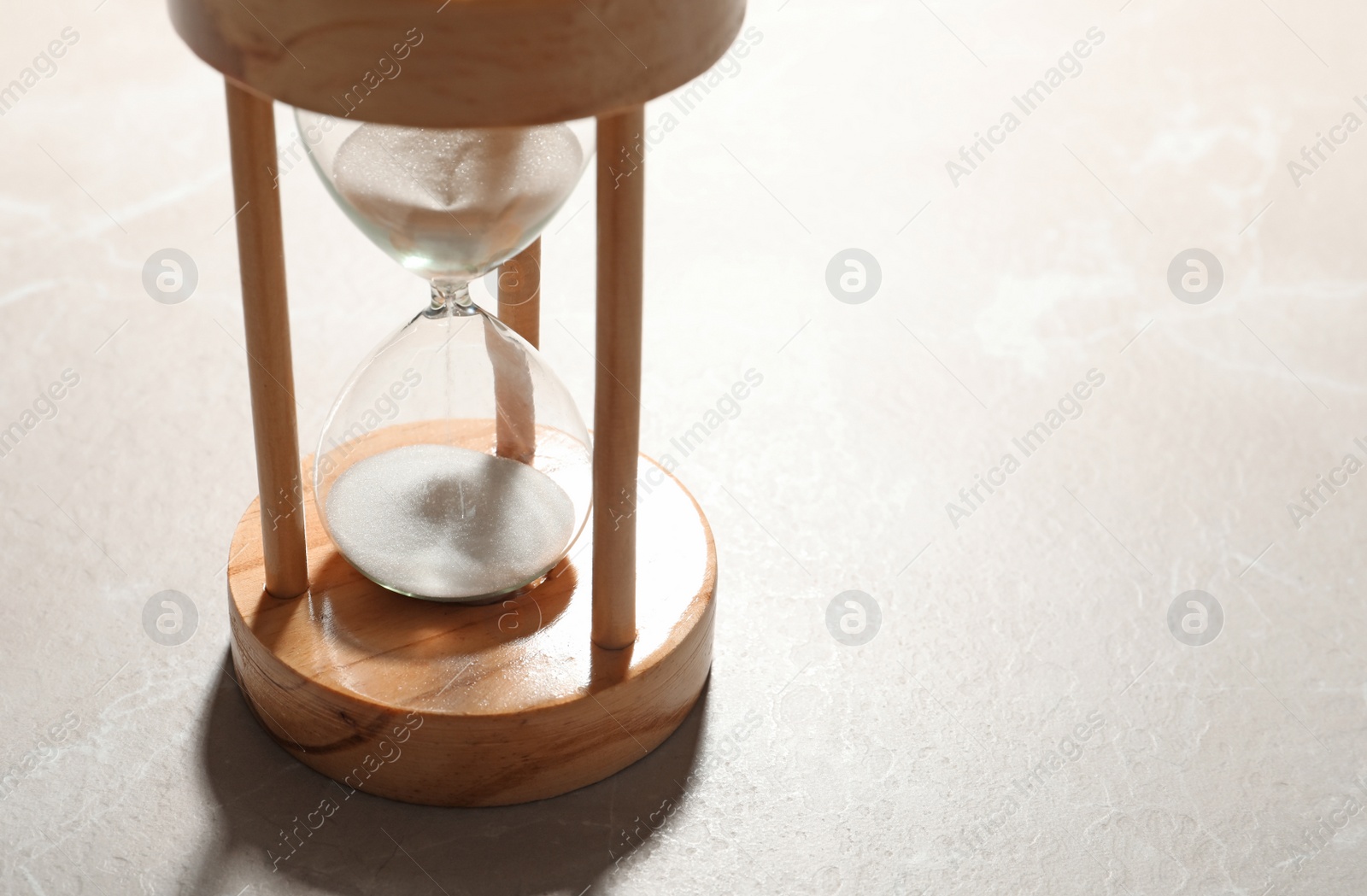 Photo of Hourglass with flowing sand on color background. Time management