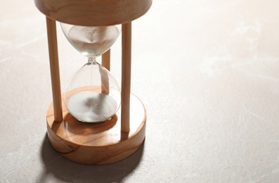 Photo of Hourglass with flowing sand on color background. Time management