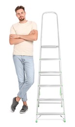 Photo of Young handsome man near metal ladder on white background