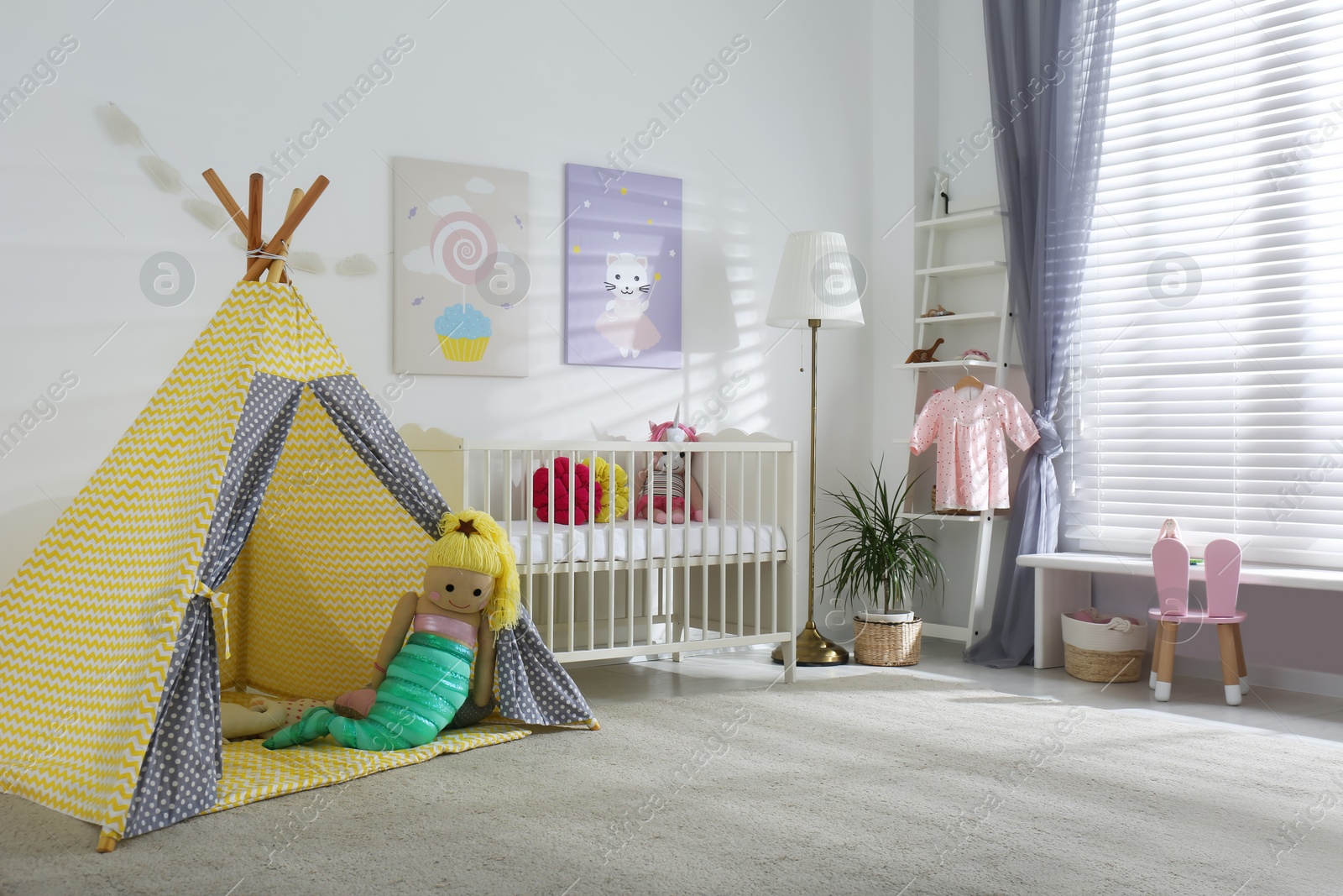 Photo of Baby room interior with cute posters, play tent and comfortable crib