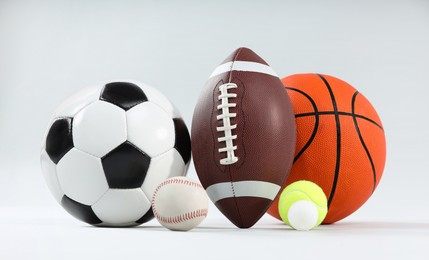 Photo of Many different sports balls on light gray background