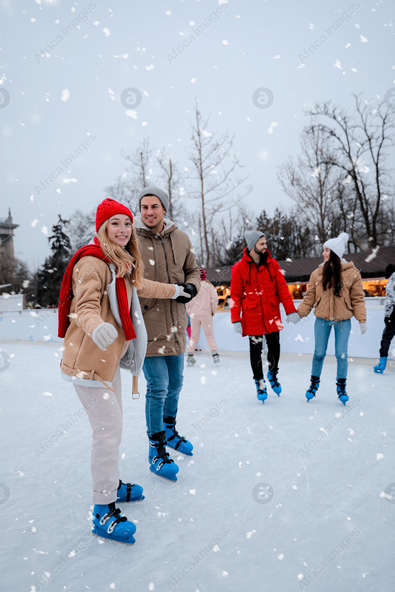 Image of Group of friends at outdoor ice skating rink