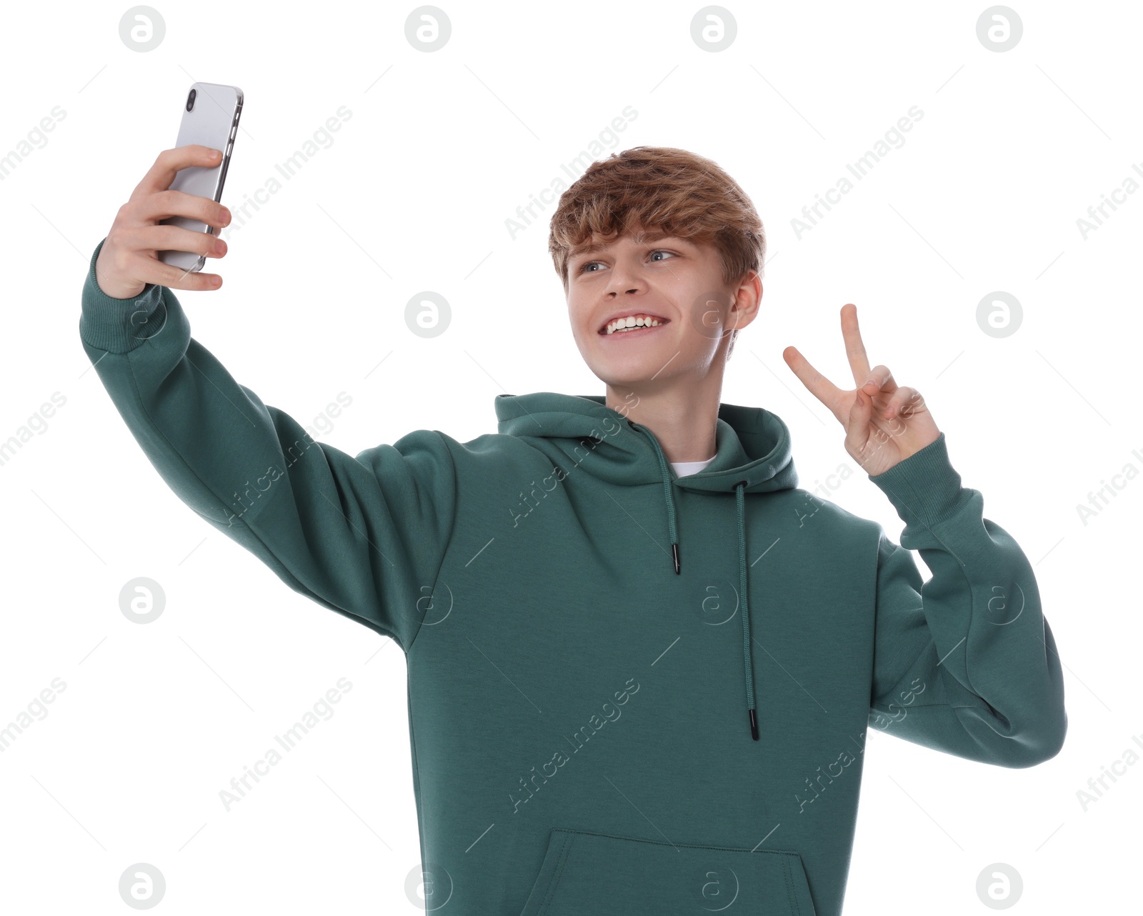Photo of Teenage boy taking selfie on white background