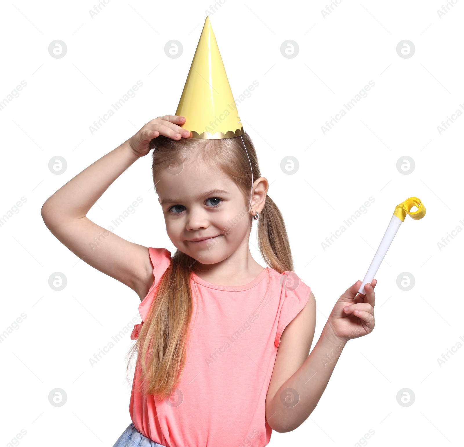 Photo of Birthday celebration. Cute little girl in party hat with blower on white background