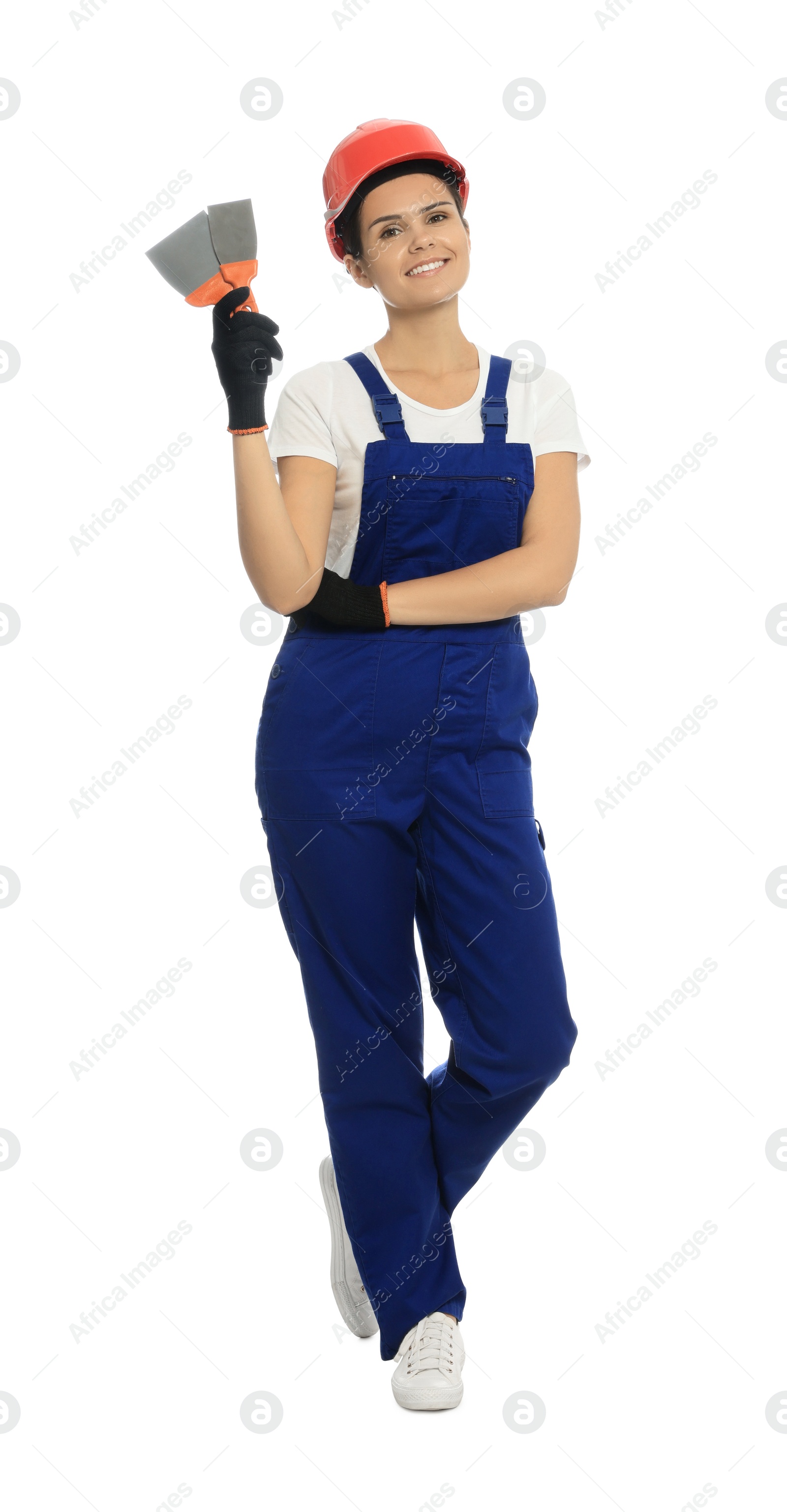 Photo of Professional worker with putty knives in hard hat on white background