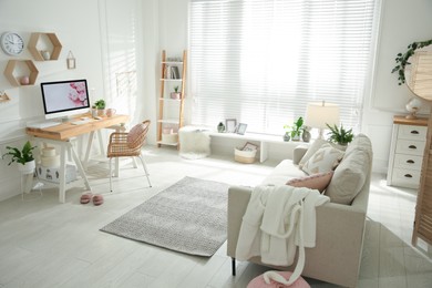 Photo of Stylish home office interior with sofa and comfortable workplace