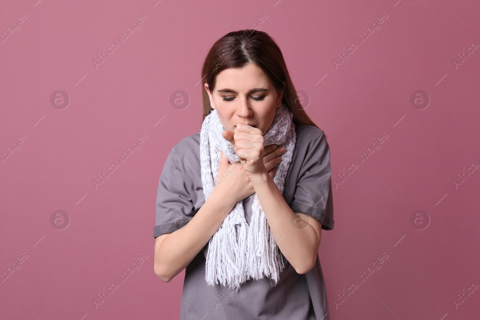 Photo of Woman coughing on color background