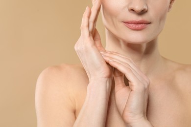 Woman with healthy skin on beige background, closeup. Space for text