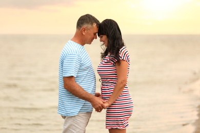 Happy mature couple spending time together on sea beach