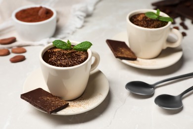 Delicious hot chocolate with fresh mint served on grey table