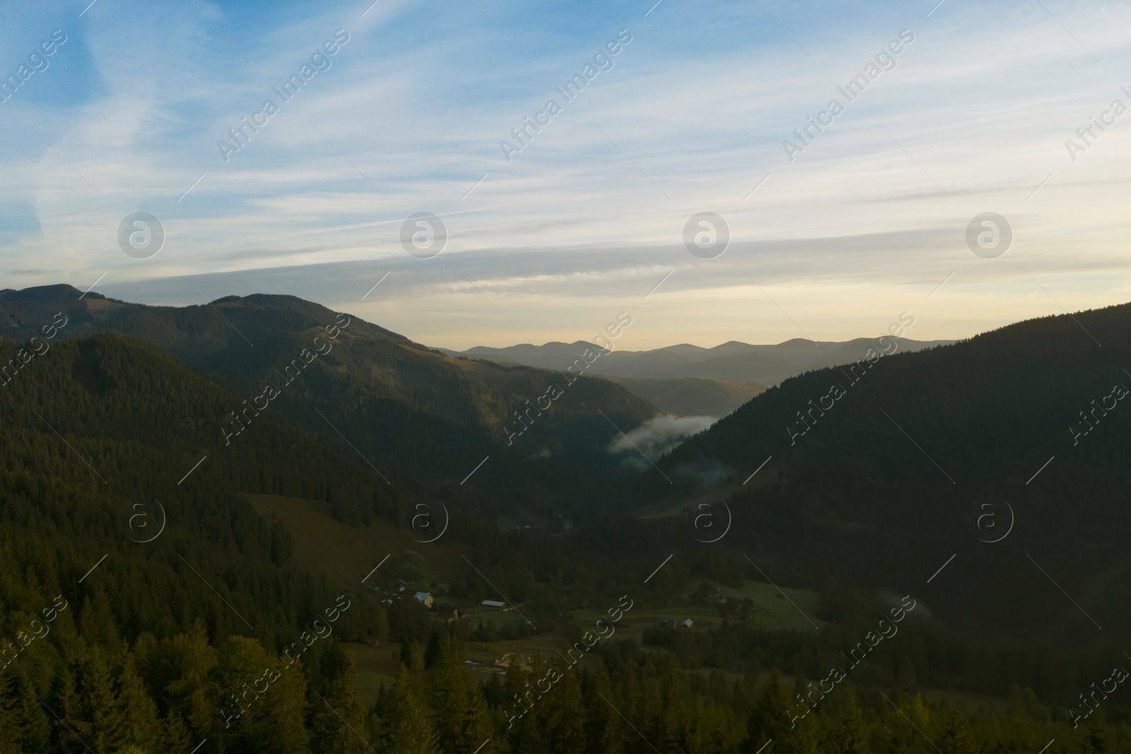 Image of Aerial view of beautiful mountain landscape with village and green trees in morning