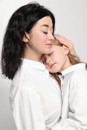 Photo of Beautiful mother with little daughter on white background