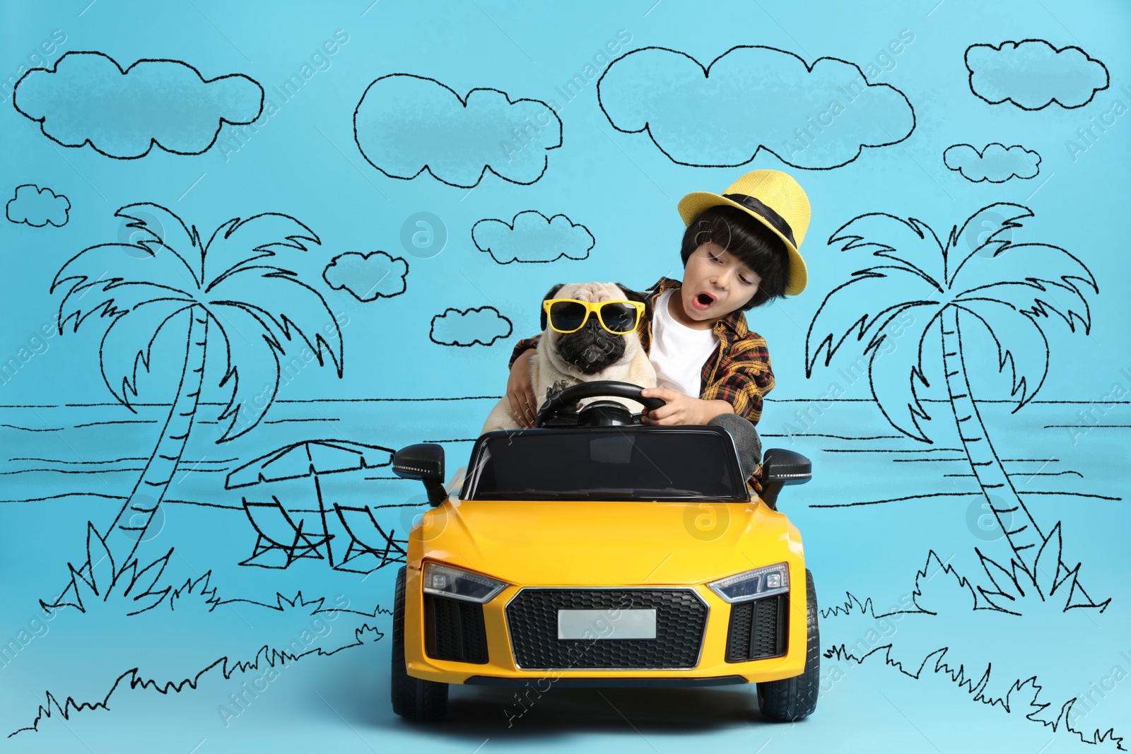 Image of Cute little boy with his dog in toy car and drawing of tropical resort on light blue background