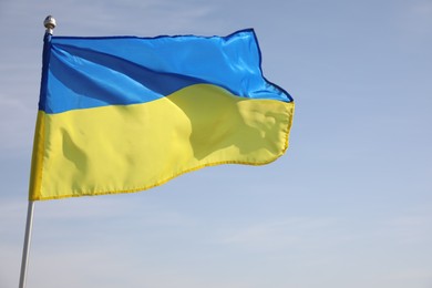 Photo of National flag of Ukraine against blue sky, closeup