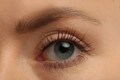 Photo of Woman with long eyelashes after mascara applying, closeup