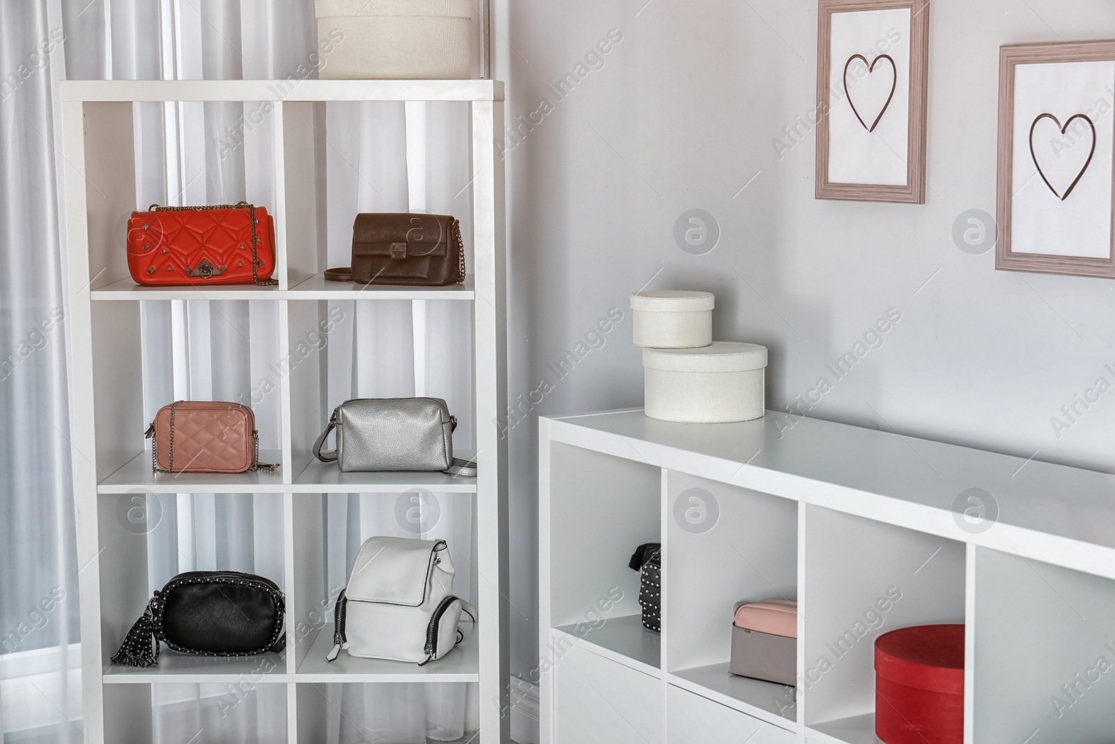 Photo of Wardrobe shelves with different stylish bags indoors. Idea for interior design