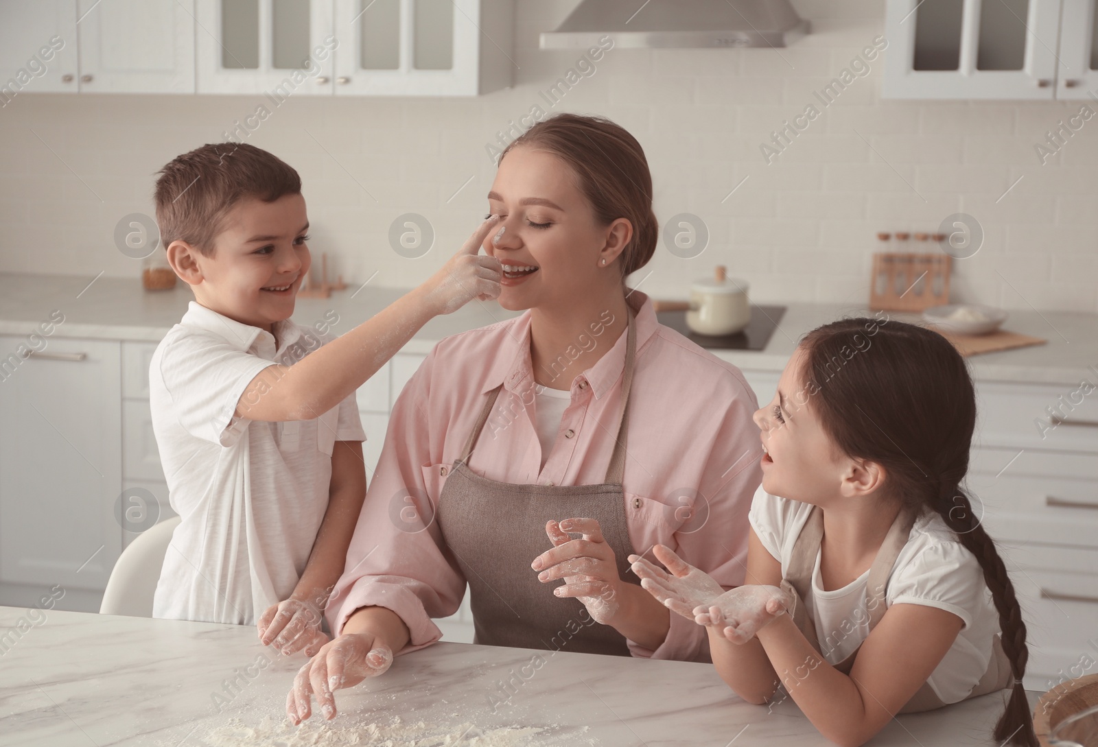 Photo of Happy family cooking together in kitchen at home