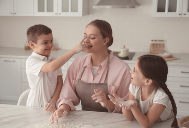 Photo of Happy family cooking together in kitchen at home