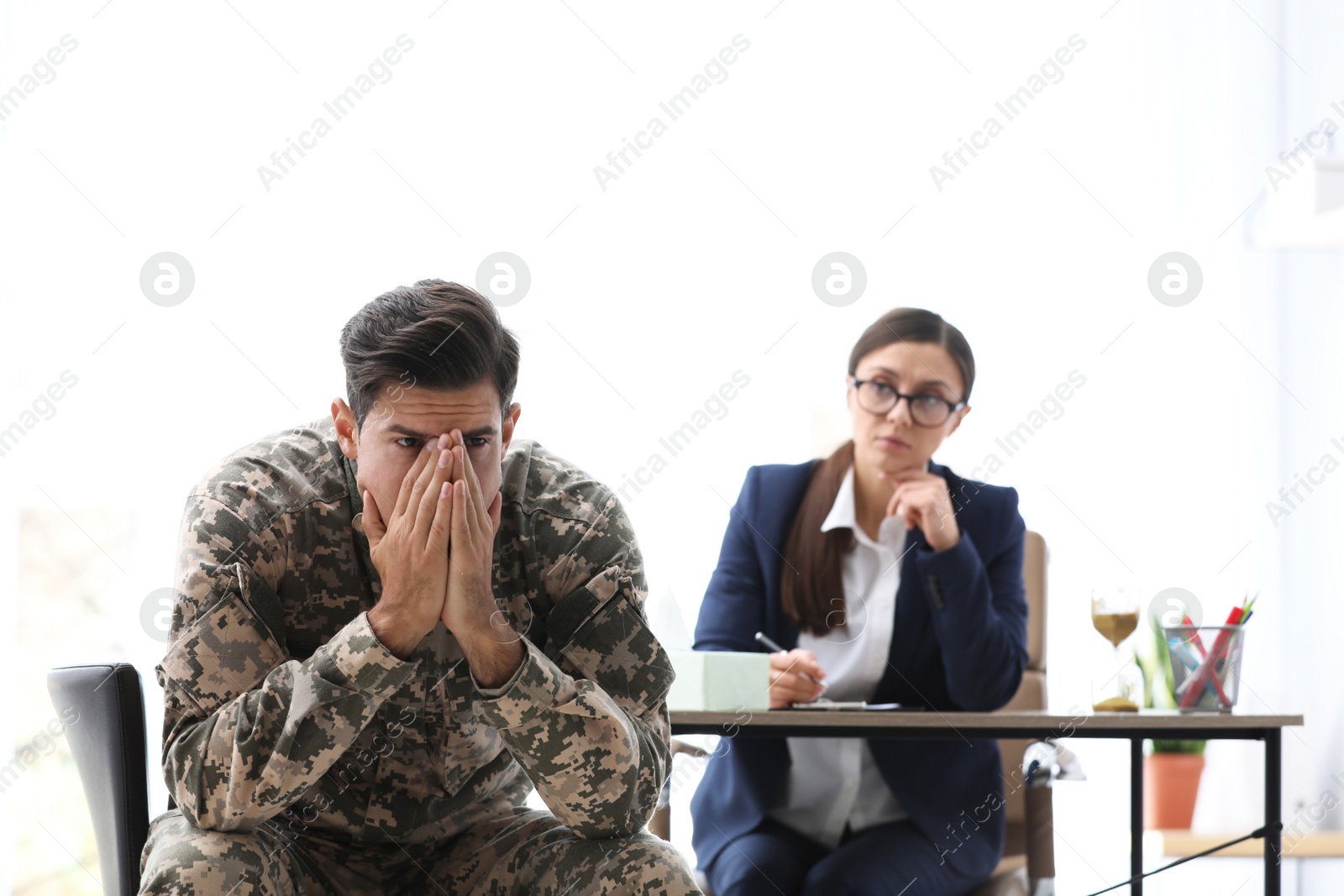 Photo of Psychotherapist working with male military officer in office
