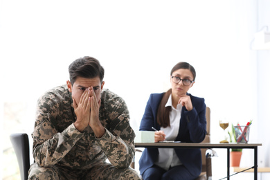 Psychotherapist working with male military officer in office