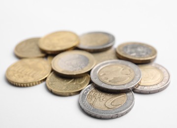 Pile of Euro coins on white background, closeup