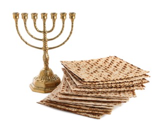 Photo of Matzo bread and menorah on white background