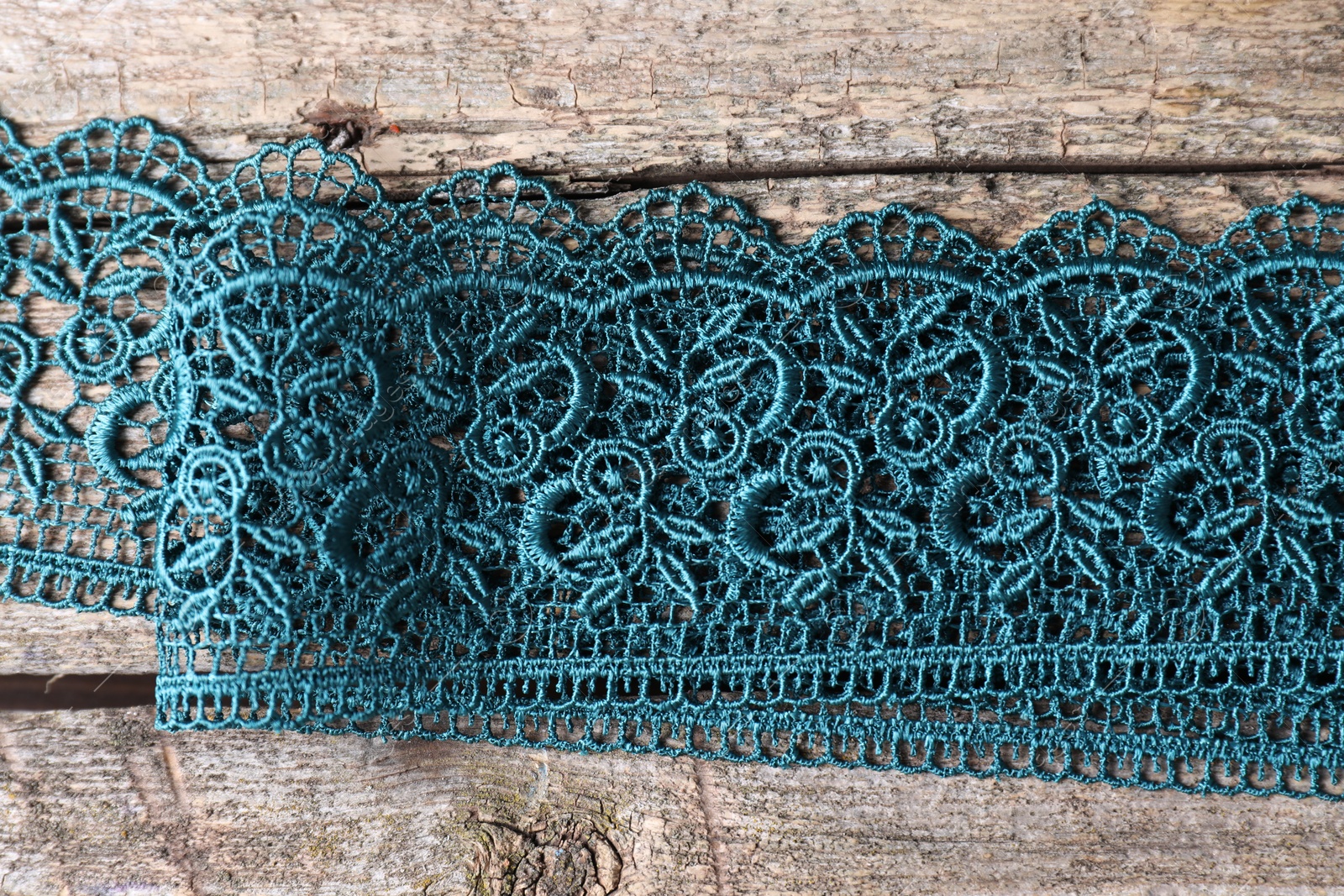 Photo of Beautiful lace on wooden table, top view