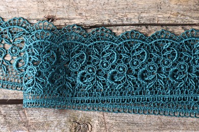 Photo of Beautiful lace on wooden table, top view