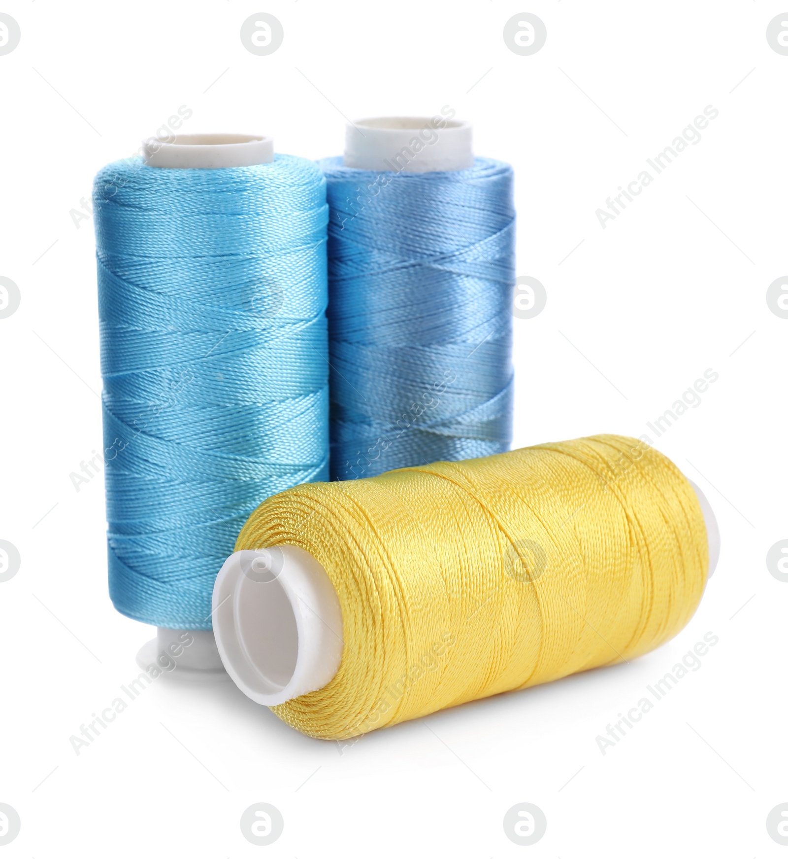 Photo of Set of colorful sewing threads on white background