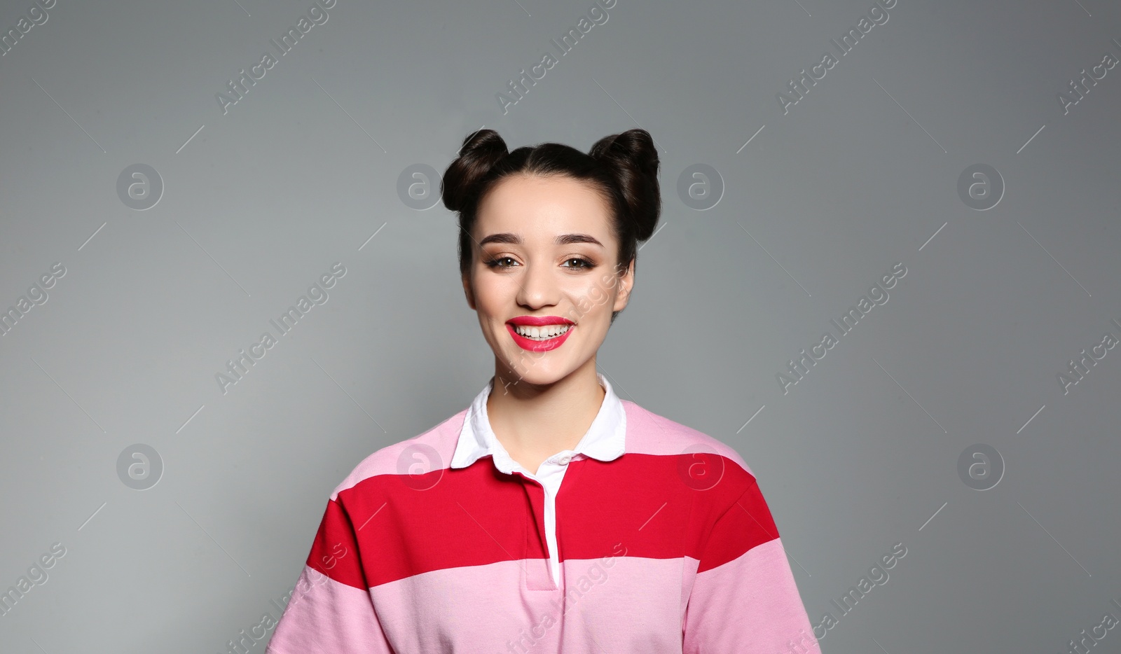 Photo of Portrait of beautiful young woman on grey background