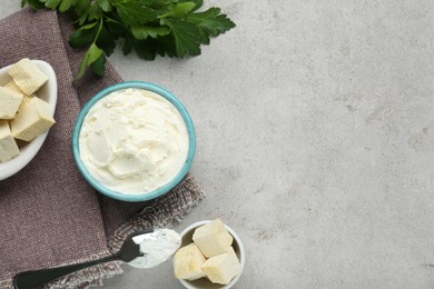 Photo of Delicious tofu cheese and spoon on light table, flat lay. Space for text