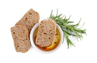 Photo of Bowl of organic balsamic vinegar with oil served with spices and bread slices isolated on white, top view