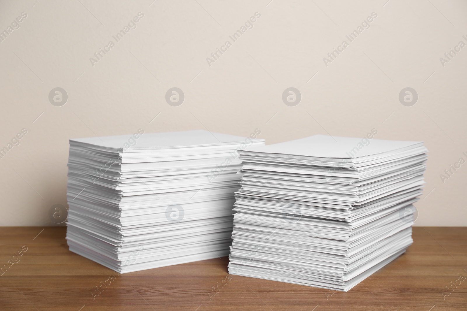 Photo of Stacks of paper sheets on wooden table