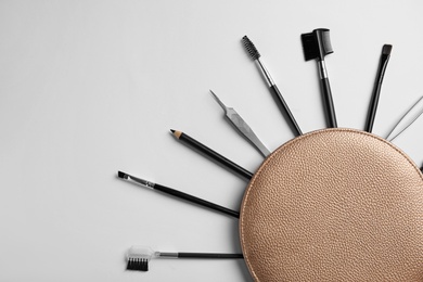 Photo of Set of professional eyebrow tools on white background, flat lay