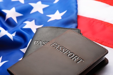 Photo of Passports in leather covers on flag of USA