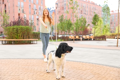 Photo of Woman walking English Springer Spaniel dog outdoors