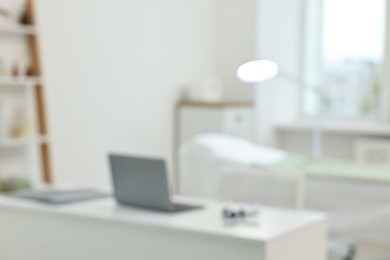 Photo of Modern interior of dermatologist's office with examination table