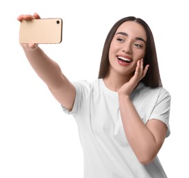 Photo of Smiling young woman taking selfie with smartphone on white background