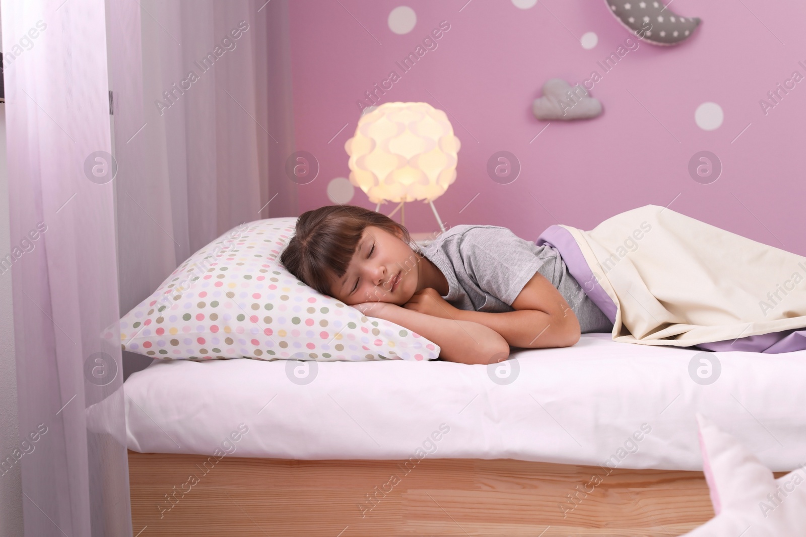 Photo of Little girl sleeping in bed at home