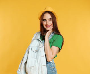 Portrait of happy woman on yellow background