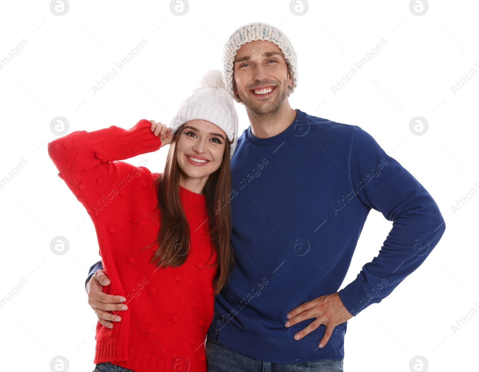 Photo of Happy young couple in warm clothes on white background. Winter season