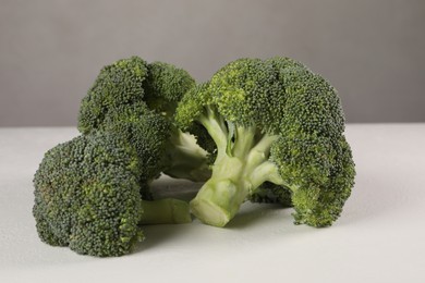 Fresh raw green broccoli on white table