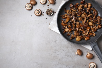 Photo of Frying pan of mushrooms on grey background, flat lay with space for text